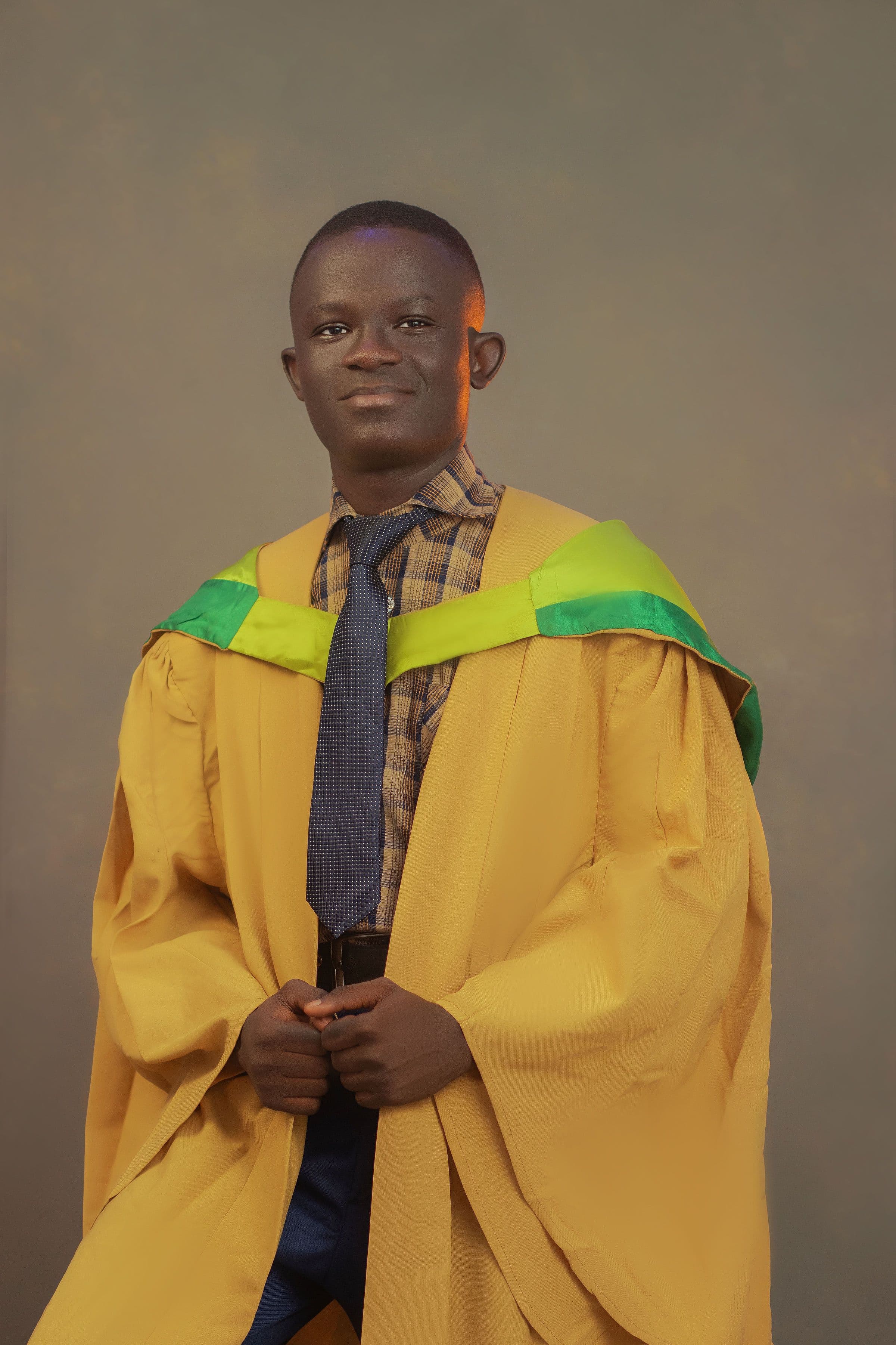Oladipo Caleb Olugbenga wearing a convocation gown